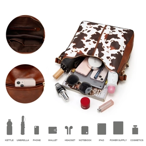 Detail showing the spacious interior and multiple pockets of the cow print tote bag