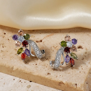 Floral stud earrings with colorful cubic zirconia and silver plating on stone background