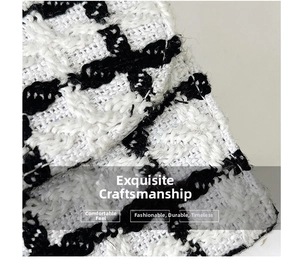 Close-up of premium black and white plaid tweed fabric texture and woven details