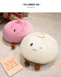Detail of plush bun pillows in pink and cream with cute facial embroidery and short legs