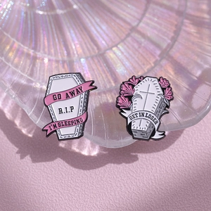 Pink gothic coffin enamel pins with R.I.P and Get In Loser slogans on shell texture