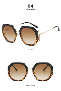 Detail of tortoiseshell oversized polygonal sunglasses with golden metal temples