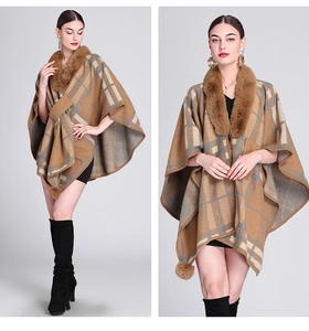 Close-up of knit poncho featuring brown plaid pattern and soft faux fur collar detail