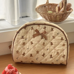 Quilted beige cosmetic bag with cute bear patterns and a stylish dark brown ribbon bow