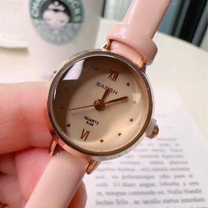 Elegant women's quartz watch with pink leather strap and rose gold case in a lifestyle setting