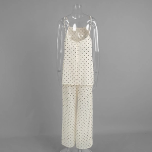 Detailed view of polka dot silk camisole and wide-leg trousers loungewear set
