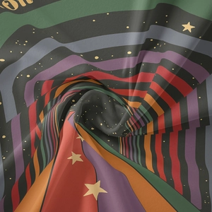 Detail of bohemian rainbow tapestry fabric featuring colorful stripes and star patterns