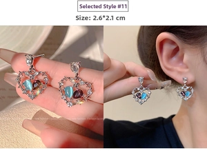 Detail view showing 2.6x2.1CM hollow heart earrings with blue stone and zirconia studs