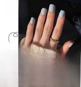 Macro detail of matte blue square press-on nails with full size range and polished finish