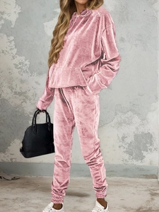 Detail view of pink velvet tracksuit with drawstring hoodie and jogger pants on model