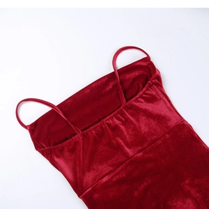 Close-up of velvet red dress showing thin straps and elastic back detail texture