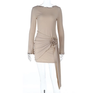 Close-up of beige knit bodycon dress featuring 3D floral accent and ruched side detailing
