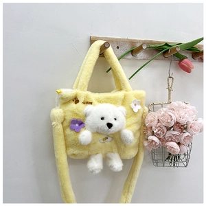 Detail of yellow plush girl bag featuring 3D white bear and sweet embroidery