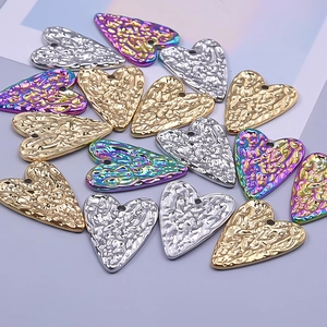 Macro detail of heart-shaped 304 stainless steel pendants with irregular hammered texture