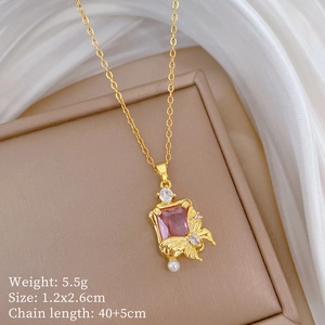 Detail view of pink gem pendant with pearl butterfly design and product specifications