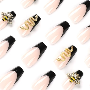 Sparkling coffin press-on nails with black French tips, 3D bee, and gold snake accents