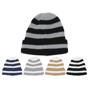 Detailed view of color block striped knit beanies in various autumn winter colorways