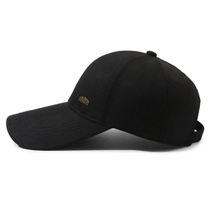 Classic black long brim baseball cap with a metal mountain logo on the side