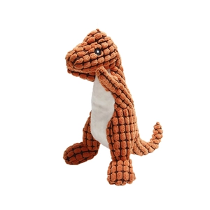 Close-up of the textured orange corn fleece fabric and stitching on the dinosaur dog toy