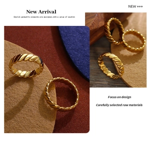 Detailed macro view of 18K gold plated twisted geometric rings with woven texture