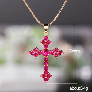 Detailed view of a 39mm cross pendant with pink crystal pavé and golden chain