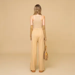 Three-piece earth tone leisure set with crop top, wide-leg pants and knit sleeves