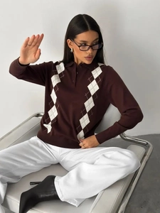 Detail of knit polo sweater featuring dark brown waffle texture and white argyle pattern