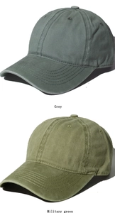 Detail view of washed cotton baseball caps in grey and military green colors