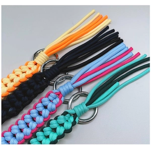 Detail of colorful hand-woven paracord keychains with metal rings and tassel ends
