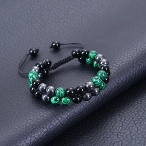 Detail of double-layer woven bracelet with malachite, obsidian beads and adjustable cord