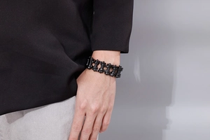 Close-up of black industrial bike chain style stainless steel bracelet on male wrist