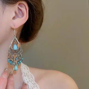 Vintage silver tassel earrings with light blue crystal drop and bohemian fringe detail