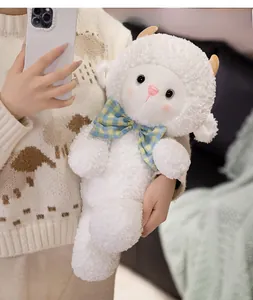 Close-up of white plush sheep toy with blue checkered bow and soft curly fleece texture