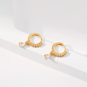 Close-up of 18K gold plated hoop earrings with red pear-cut zircon pendants