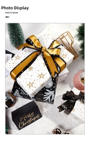 Detailed view of Christmas gift boxes with gold foil star patterns and luxury satin ribbons