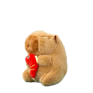 Adorable brown plush capybara keychain holding a small red fish decorative ornament