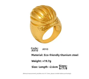 Detailed view of vintage oval textured gold ring with shell-shaped bulb and hammered finish
