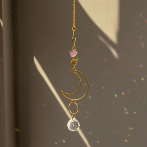 Golden suncatcher with amethyst raw stone and faceted crystal ball casting rainbows