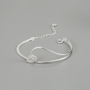 Detailed macro view of S925 sterling silver knotted bracelet with woven mesh chain