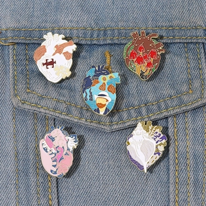 Creative oil painting heart enamel pins set with artistic motifs on blue denim jacket