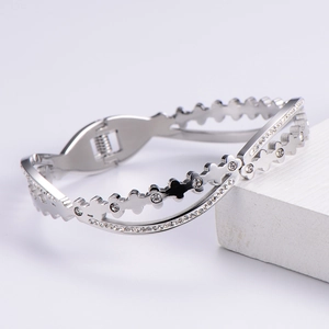 Silver-plated cuff bracelet with sparkling white zircons on a textured white stone base