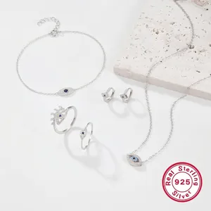 Elegant S925 sterling silver evil eye jewelry set with blue stones on a stone slab