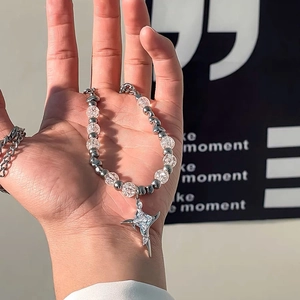 Titanium steel bracelet featuring ice-crack beads and a star pendant held in hand
