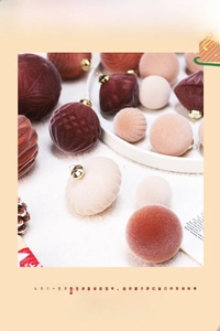 Detail view of flocked burgundy and brown Christmas balls on white plush background