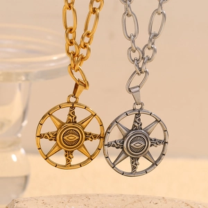 Gold and silver 18K plated stainless steel star and evil eye necklaces on a stone base