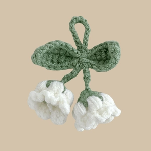 Handmade crochet lily of the valley keychain with white bells and green leaves