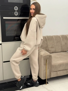 Apricot oversized hoodie and joggers tracksuit set worn by model for street style