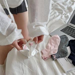 Detail of sweet cotton boat socks with pink bow embroidery and polka dot jacquard pattern