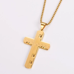 Detailed view of a gold layered cross pendant necklace with textured steel finish