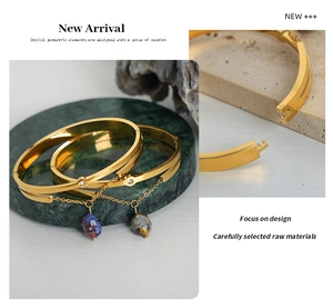 Detail of vintage gold-plated titanium steel bracelet with natural stone charms on marble